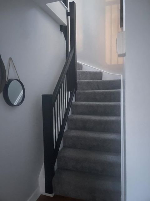 Staircase with black balustrade, viewed from below